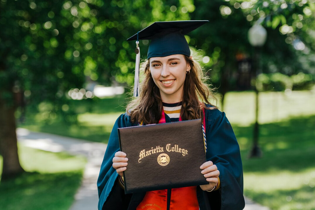 happy graduate holding certificate